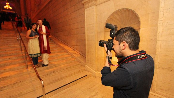 Guest holding a camera prop at a live photo shoot