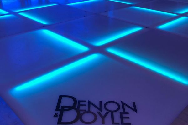 Bright LED dance floor filling the event room
