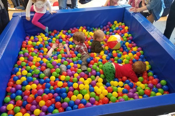 Guests laughing in the ball pit photo booth