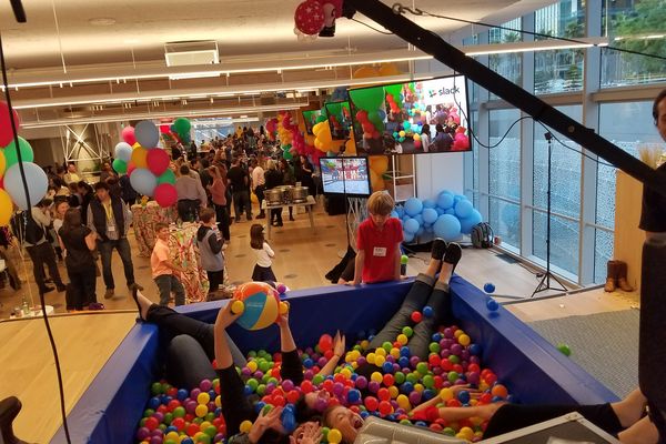 Group posing together in the ball pit photo booth