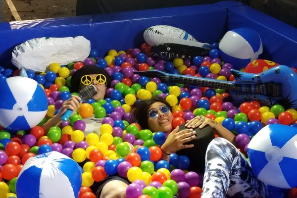 Event guest posing with ball pit photo booth props
