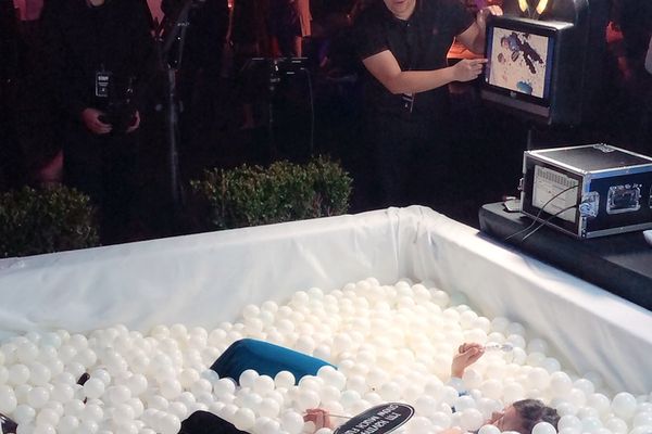 Guest in a white ball pit photo booth