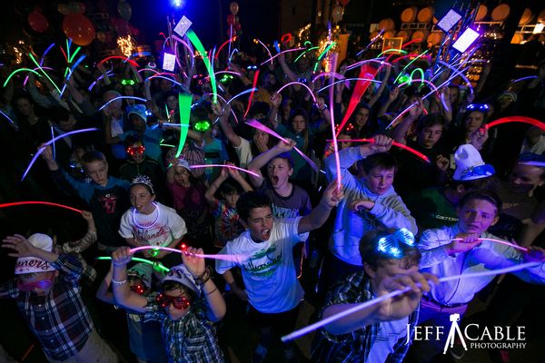 Guests enjoying a blacklight dance floor