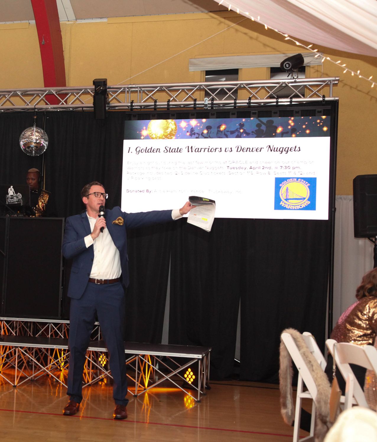 Corporate presenter speaking at a company event with AV support