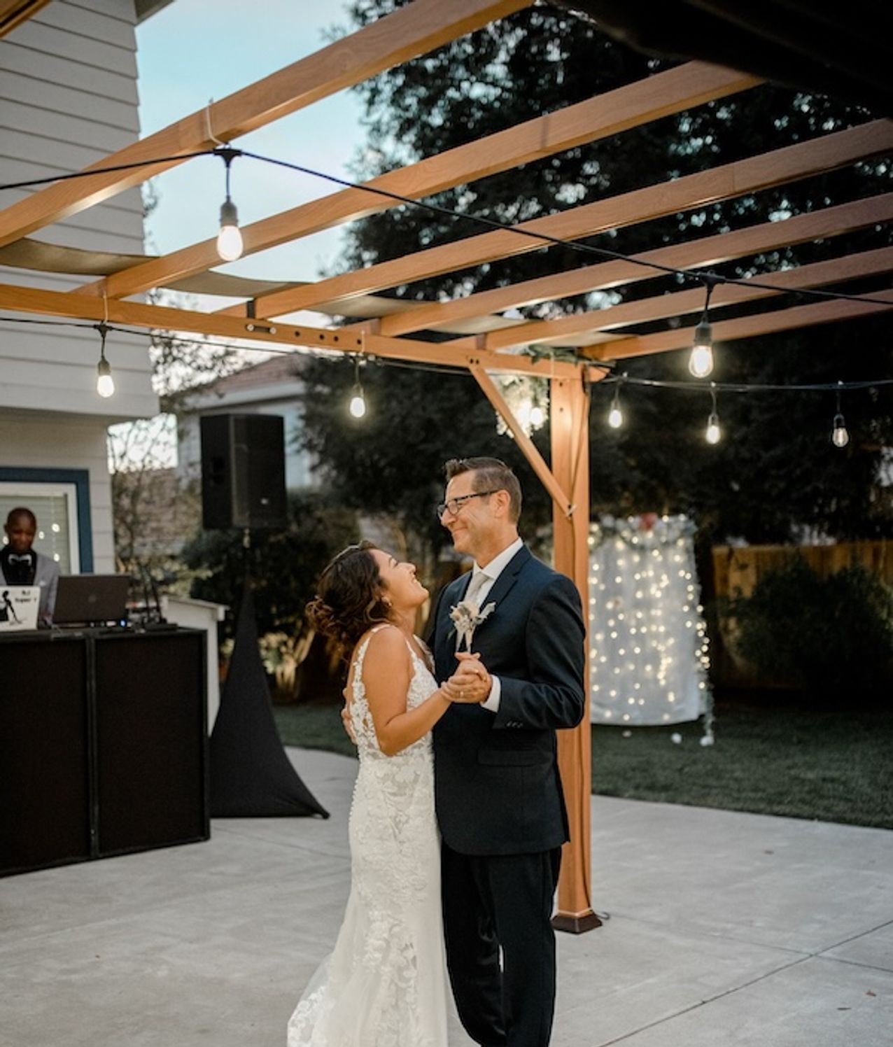 Wedding couple dancing in front of a DJ setup