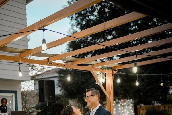 Wedding couple dancing in front of DJ lights