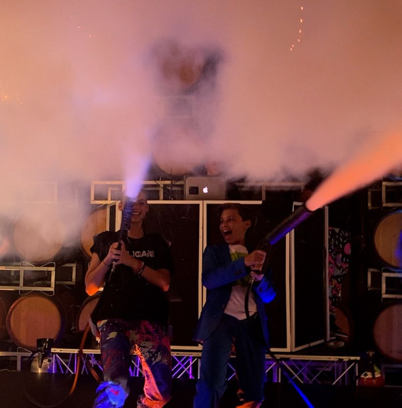 DJ booth with lights and fog at a high-energy event