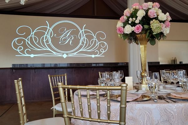 Event room with monogram gobo and uplighting