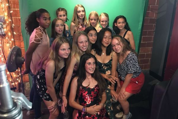 Large group using the green screen photo experience