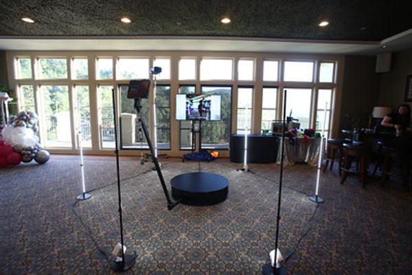 360 photo booth guests posing with props