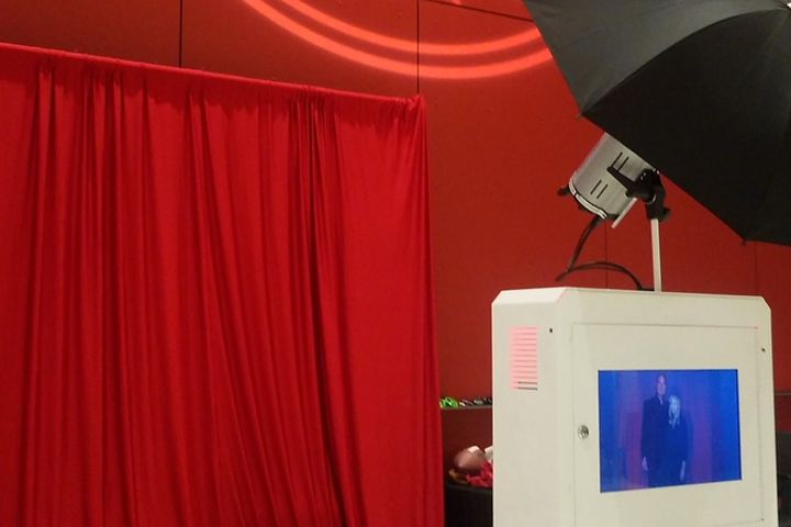 Branded open style photo booth backdrop at an event