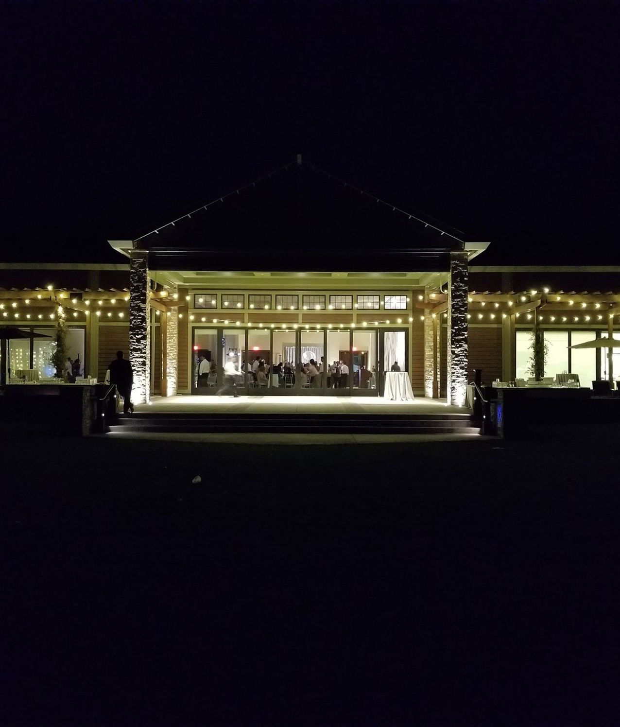 Outdoor reception tables under warm market lighting