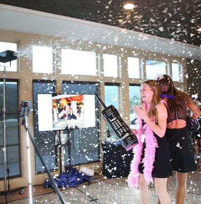 Guests using a 360 photo booth at an event