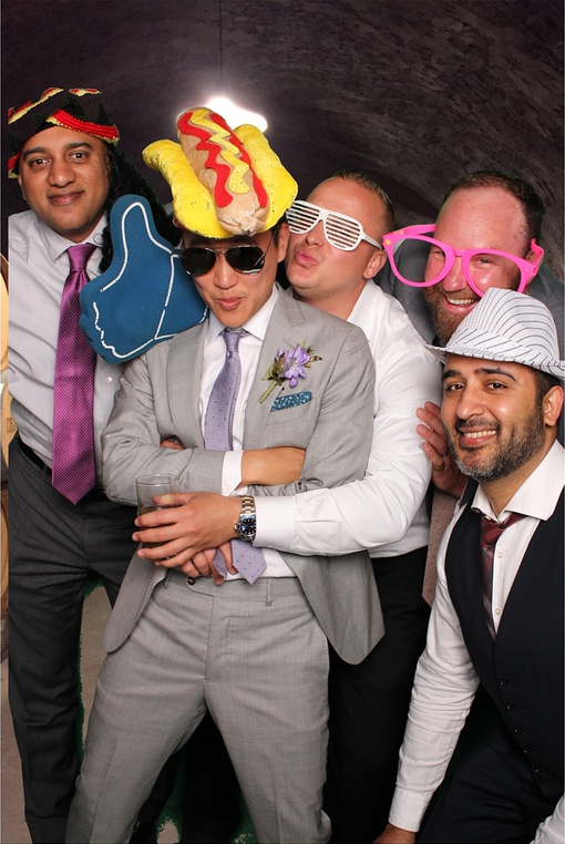 Guests posing in a photo booth with props