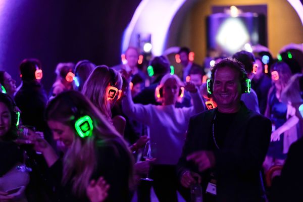 Silent disco guests with multicolored headset LEDs