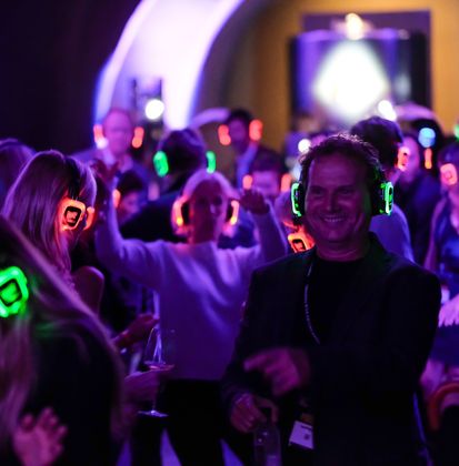 Students wearing silent disco headphones at an event