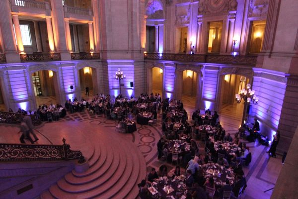 Event room with purple uplighting around the dance floor