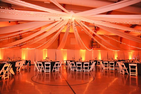 Corporate event stage with warm amber uplighting