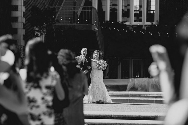 Wedding couple dancing in front of a DJ setup